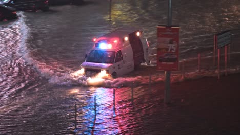 On-April-16,-2024,-an-ambulance-navigated-through-rain-on-a-flooded-road-in-Sharjah,-UAE,-after-record-breaking-rains-hit-the-country