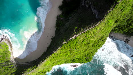 Surrounded-by-ocean-water,-terrain-of-limestone-covered-in-vegetation