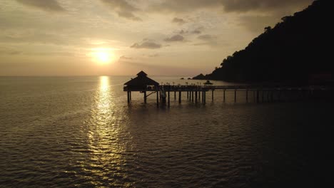 Circular-flight-around-a-tropical-island-resort-during-sunset