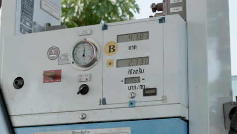 Numbers-for-amount-of-liters-and-price-equivalent-in-Baht-are-displayed-on-a-gauge-machine-at-a-refuelling-station-in-Bangkok,-Thailand