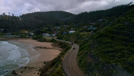Cars-drive-along-Australia's-iconic-Great-Ocean-Road-coastal-highway-near-Separation-Creek-town-on-cloudy-day-in-Victoria