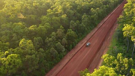 Aerial-clip-of-4x4-driving-in-remote-outback-Australia,-late-afternoon-on-red-dirt-road,-clip-two