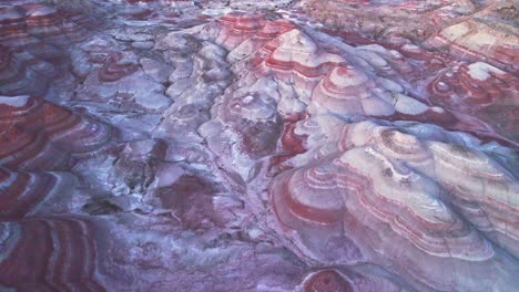 Aerial-4k-drone-view-of-Bentonite-Hills,-Utah,-colorful-mars-like-landscape-appear-as-softly-contoured,-banded-hills-in-varying-hues-of-brown,-red,-purple,-gray,-and-green