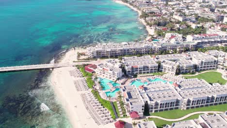 Drone-Shot-of-Playa-Del-Carmen-Mexico-Luxury-Waterfront-Buildings-and-Pier