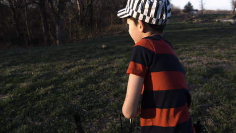 Portrait-Of-A-Young-Boy-Shoots-An-Arrow-From-Bow