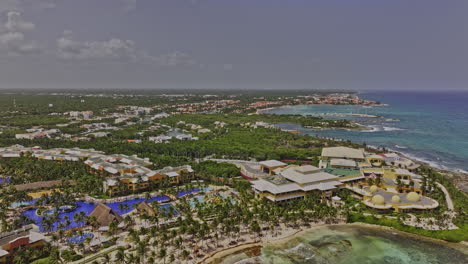 Puerto-Aventuras-Mexico-Aerial-v8-drone-flyover-seafront-resorts-capturing-sandy-beach,-homes,-marina,-cove-and-the-vibrant-coastal-community-with-ocean-views---Shot-with-Mavic-3-Pro-Cine---July-2023