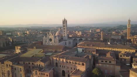 aerial-cityscape-view-of-Siena-city-on-Tuscany-Italy-with-cathedral-dome-at-sunset,-characteristic-Italian-village-in-medieval-gothic-style