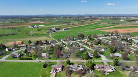 Small-American-suburb-and-farm-house-with-rural-fields-during-sunlight-in-spring