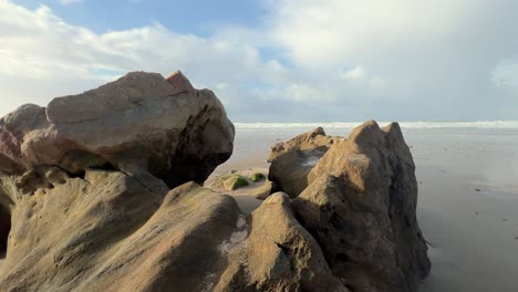 Spain's-rugged-and-rocky-coastline-is-outlined-by-the-crashing-waves-of-the-ocean-on-the-horizon,-capturing-a-tranquil-daytime-vista-of-natural-splendor