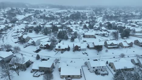 High-aerial-of-housing-development-covered-in-snow-during-winter