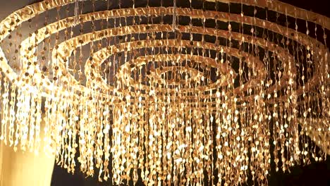 An-amazing-close-up-view-of-a-spiral-chandelier-from-a-classic-Asian-wedding,-The-stunning-details-are-truly-impressive