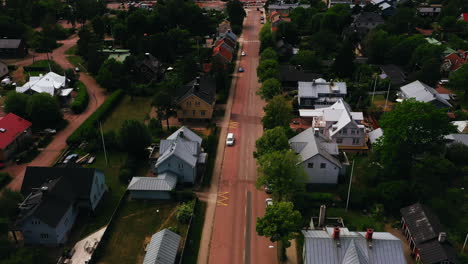 Aerial-tilt-shot-over-streets,-toward-a-cruise-liner-at-the-Maarianhamina-port,-in-Aland,-Finland