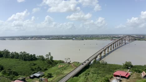 Drone-view-of-Jules-Wijdenbosch-bridge-captured-with-mavic-2-pro,-orbiting-around-bridge,-Suriname-river-in-port-of-Paramaribo,-capital-of-Suriname