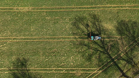 Aerial-View-Of-Crop-Sprayer-Spraying-Fertilizer-On-Farm-Field