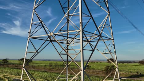 Drone-circling-around-metal-structure-revealing-sun