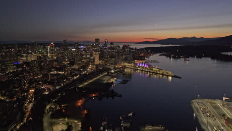 Vancouver-BC-Canada-Aerial-v72-cinematic-drone-flyover-the-harbour-capturing-illuminated-downtown-cityscape-at-night-with-sunset-dusk-sky-views---Shot-with-Mavic-3-Pro-Cine---July-2023