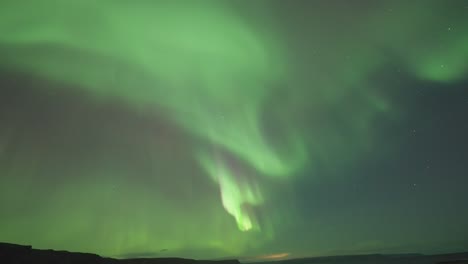 Mesmerizing-northern-lights-dance-above-a-tranquil-fjord-on-a-dark-winter-night