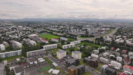 Aerial-View-of-Reykjavik-Iceland-Residential-Suburbs,-Sport-Fields,-Buildings-and-Streets