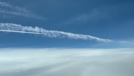 Exclusive-aerial-shot-from-a-plane-cockpit-of-another-preceding-jet-flying-over-a-previous-weak-on-the-left-side