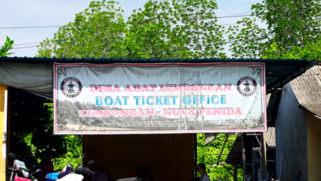 Boat-Ticket-Office-Signage-Offering-Trip-From-Nusa-Lembongan-To-Nusa-Penida-In-Bali,-Indonesia
