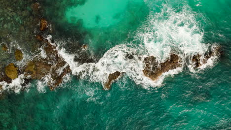 Ocean-waves-crashing-on-rocky-coast,-tropical-marine-landscape