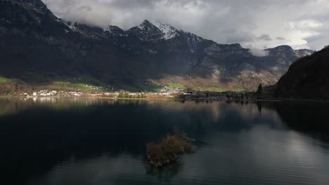 Drone-shot-of-Alps-in-Walensee,-Switzerland-under-a-cloudy-day