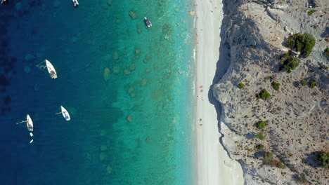 Aerial:-Top-down-orbit-drone-shot-of-Lalaria-beach-in-Skiathos-island,-Sporades,-Greece-with-turquoise-crystal-cleat-water