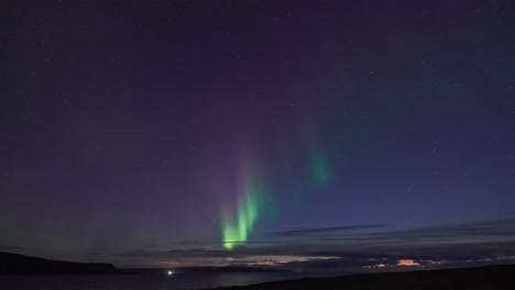 The-captivating-dance-of-the-Aurora-Borealis-in-the-winter-sky-illuminates-the-dark-still-waters-of-the-fjord