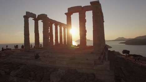 aerial-drone-footage-of-ancient-ruins-of-Temple-of-Poseidon-,-Sounion-Greece-at-golden-hour