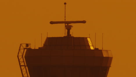 extreme-close-up-of-Air-traffic-control-tower-in-airport-at-sunset-with-orange-sky