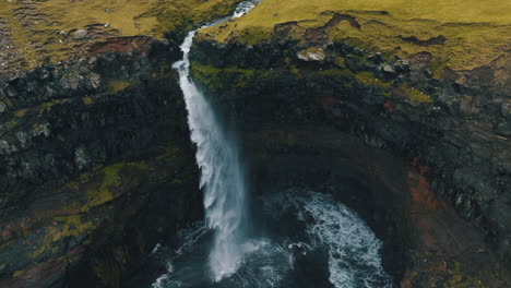 Mulafossur-waterfall,-Faroe-Islands:-fantastic-aerial-view-in-orbit-over-the-beautiful-waterfall-and-the-wind-hitting-the-water