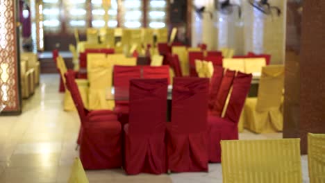 An-amazing-shot-of-the-dining-area-at-a-classic-Asian-wedding,-decorated-in-a-stunning-red-and-golden-theme