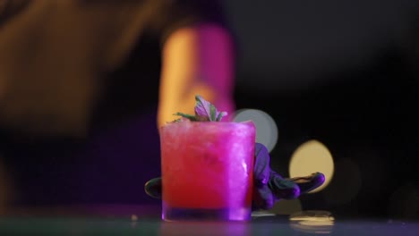 The-bartender-slides-a-refreshing-red-fruit-cocktail-onto-the-bar-counter