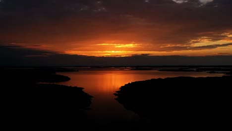 Hyperlapse-drone-shot-dramatic-sunset-above-small-islands,-in-the-Aland-archipelago,-Finland