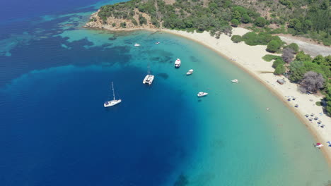 Aerial:-Panoramic-drone-shot-of-Tsougria-island-beach-near-Skiathos,-Sporades,-Greece-with-amazing-turquoise-and-emerald-crystal-clear-water