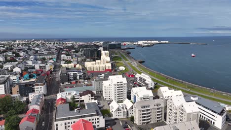 Drone-Shot-of-Reykjavik-Iceland-Cityscape,-Waterfront-Buildings,-Harbor-and-Coastal-Traffic
