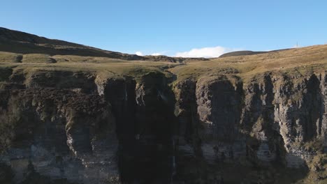 Devil’s-Chimney-name-comes-from-the-phenomenon-where-southerly-winds-sometimes-blow-the-water-backwards-up-and-over-the-cliff-edge---4K-Cinematic-Drone-Footage---Co