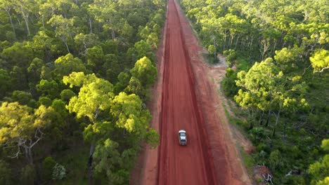 Aerial-clip-of-4x4-driving-in-remote-outback-Australia,-late-afternoon-on-red-dirt-road,-clip-one