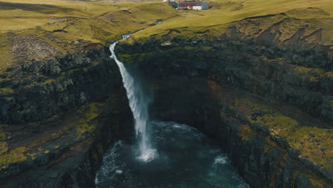 Mulafossur-waterfall,-Faroe-Islands:-fantastic-aerial-view-in-orbit-of-the-beautiful-waterfall-and-the-wind-hitting-the-water