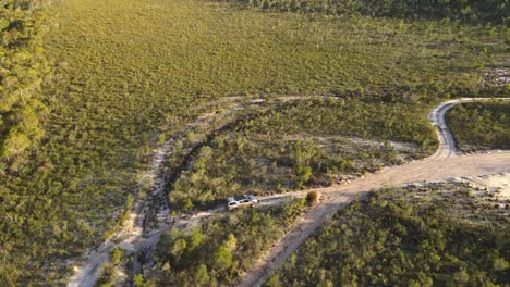 Aerial-clip-of-4x4-driving-slowly-in-remote-outback-Australia,-late-afternoon-on-bush-track,-clip-two
