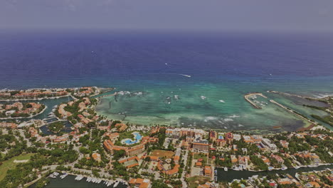 Puerto-Aventuras-Mexico-Aerial-v3-cinematic-flyover-seafront-resorts-and-vacation-homes-capturing-marina,-La-Bocana-cove-and-the-endless-views-of-ocean-horizon---Shot-with-Mavic-3-Pro-Cine---July-2023