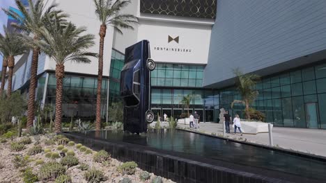 People-walking-into-the-entrance-of-the-Fountainbleau-hotel-in-Las-Vegas,-Nevada,-Slowed-to-Half-speed