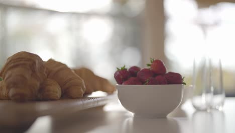 fresh-French-Croissant-pastry-with-organic-natural-strawberry-,-healthy-breakfast-on-Kitchen-counter-with-warm-morning-natural-light-,-close-up