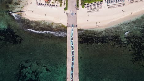 Playa-Del-Carmen,-Mexico,-Aerial-View-of-Pier-and-Luxury-Waterfront-Buildings,-Revealing-Drone-Shot