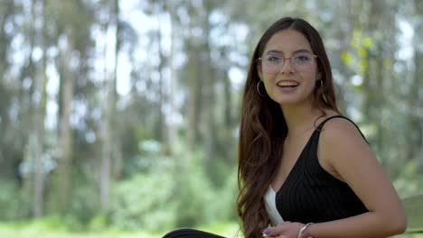 Engaging-Ecuadorian-woman-in-stylish-black-and-white-attire,-sporting-glasses