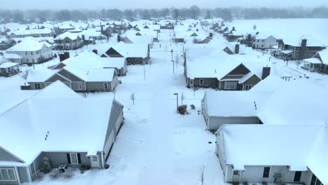 Aerial-view-of-a-suburban-neighborhood-with-snow-covered-houses-and-streets