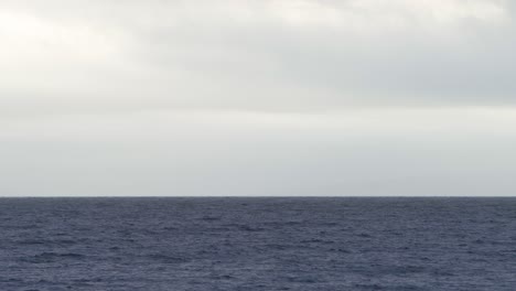 Static-Shot-Looking-Out-to-Sea-Level-Horizon-On-Cloudy-Day