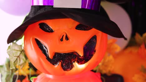 plastic-pumpkin-with-halloween-lantern-shaped-hat-in-colorful-decoration