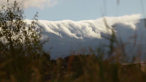 A-timelapse-of-clouds-rolling-over-the-mountains-in-Montana