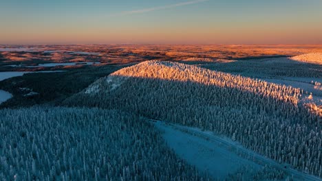Winter-landscape-with-fells-and-polar-nature,-evening-in-Lapland---Aerial-view